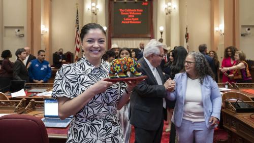 Senator Gonzalez presents the 2024 Latino Spirit Award Huichol bear
