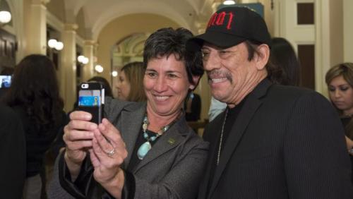 Assembly Member Susan Talamantes Eggman takes selfie with Latino Spirit Award Honoree Danny Trejo